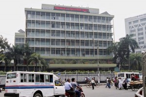 Commuters pass by the front of the Bangladesh central bank building in Dhaka